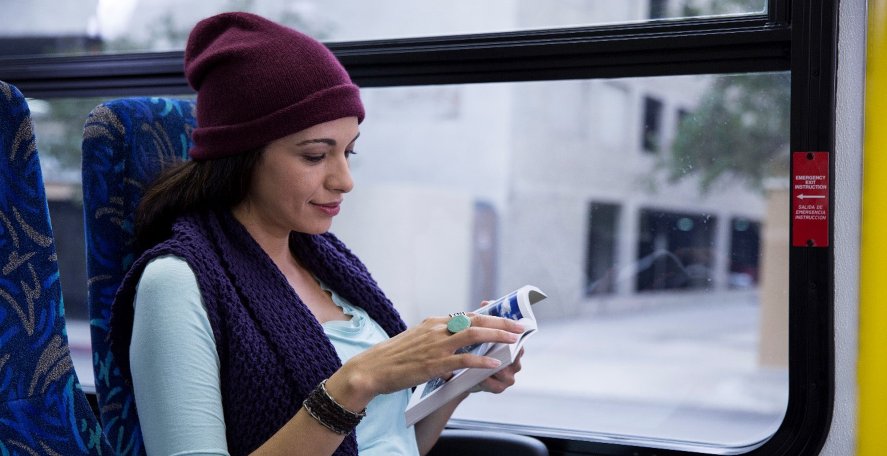 customer on a bus reads a book