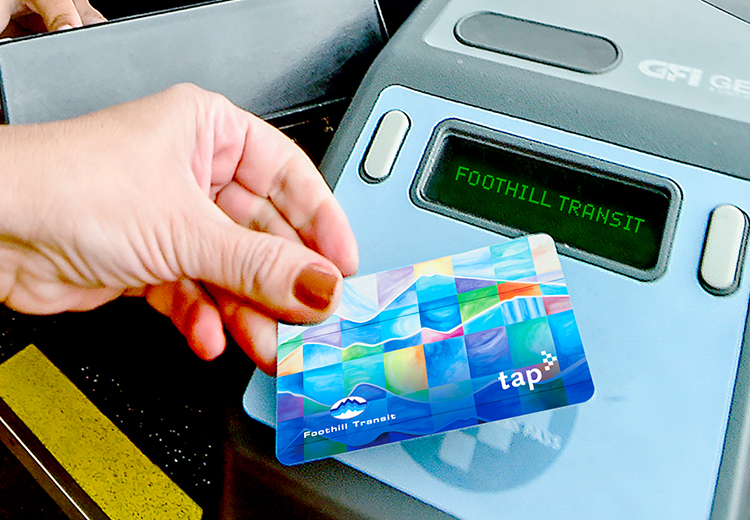 a hand holds a TAP card to a validator