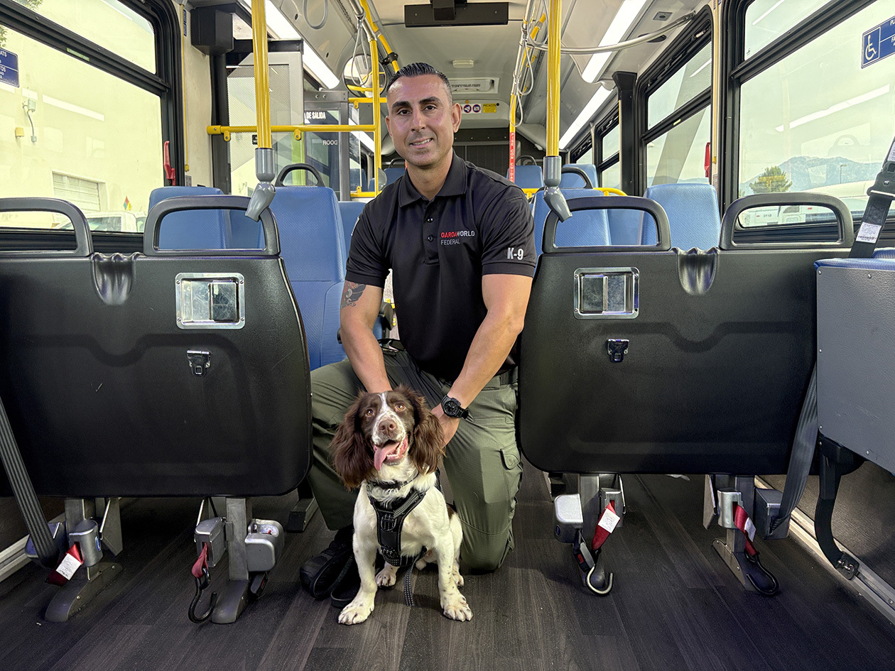 Thundra and her handler Martin pose inside of a Foothill Transit bus