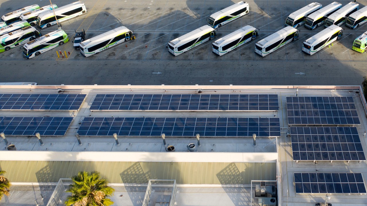 an aerial view of a Foothill Transit operations yard showing the roof solar panels and parked buses