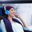 image: customer laughs while wearing headphones on a bus 