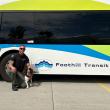 Thundra and her handler Martin pose in front of a Foothill Transit bus