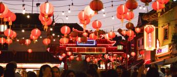 lanterns in Chinatown shine on a crowd celebrating Mid-Autumn Mood Festival