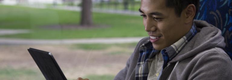 customer reading a tablet on the bus