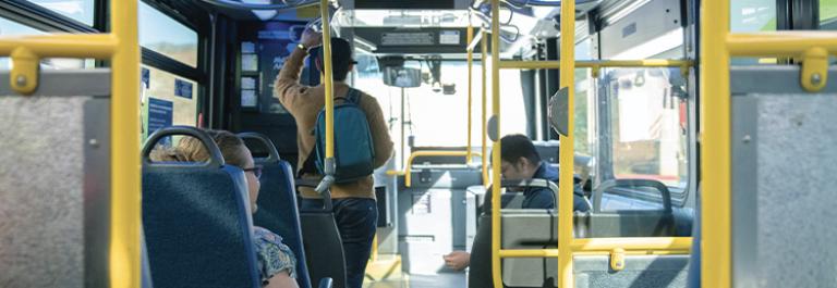 customers on a bus viewed from behind
