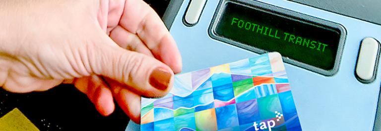 a hand holds a TAP card to a validator