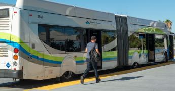 a customer walks towards the front of a Silver Streak bus