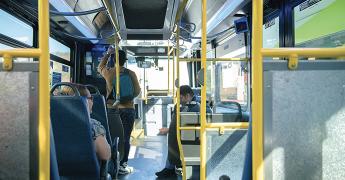 customers on a bus viewed from behind