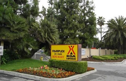 Yellow sign: Fairplex RV Park, Mini Mart, KOA Kampground