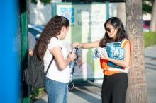 A member of the Foothill Transit marketing team talks with a customer.